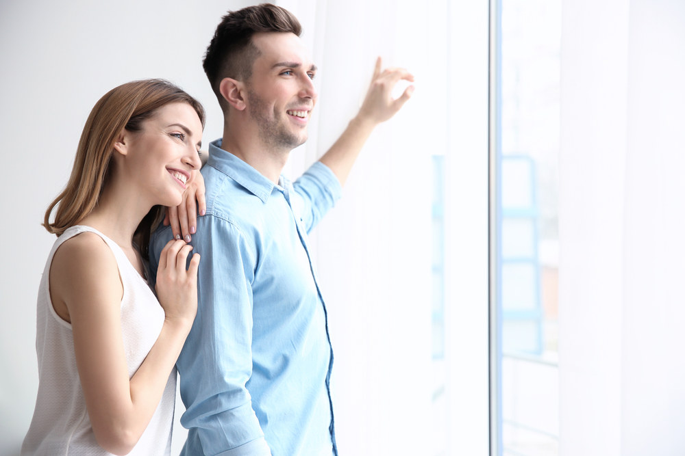 Young girl push her hands on her ears trying to not to hear the loud noise from neighbor Soundproof Replacement Windows