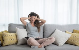 Young girl push her hands on her ears trying to not to hear the loud noise from neighbor Soundproof Replacement Windows