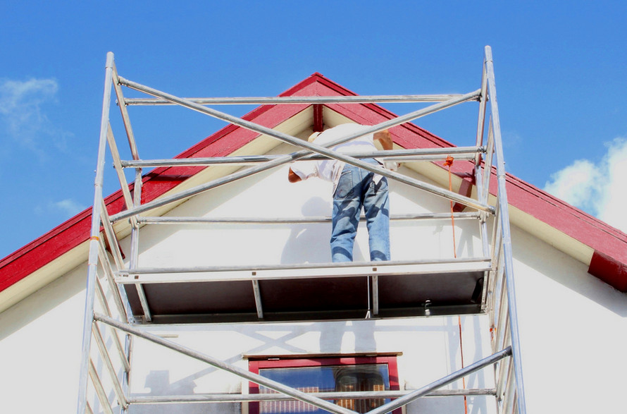 Man painting home's exterior