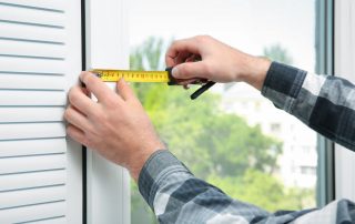 Man measuring his windows